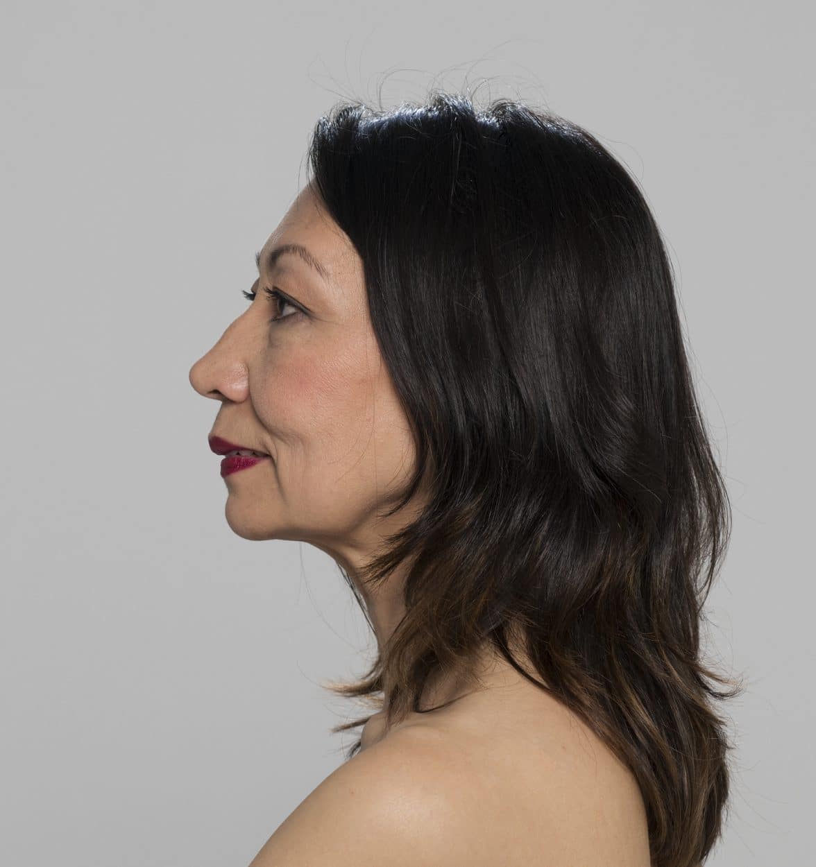 Woman standing against grey background